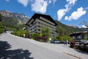 a large building on the side of a road at Sweet Home Brevent - Happy Rentals in Chamonix