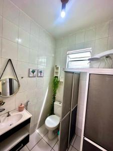 a bathroom with a toilet and a sink at Ap8 atrás da Passarela do caranguejo- Orla de Atalaia in Aracaju
