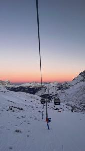 wyciąg narciarski w śniegu o zachodzie słońca w obiekcie Albergo Pensione Sport w Arabbie