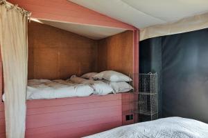 two beds sitting on a pink wall in a room at Finest Retreats - Foxley Lodge in Little Walsingham
