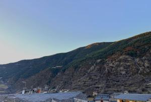 una montaña con casas frente a una ciudad en Refugio alpino a 5 min de pistas en Encamp