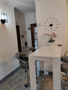 a room with a table and chairs and a clock on the wall at Westview in Buckie