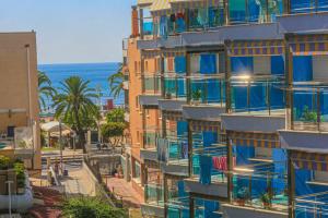 an apartment building with blue balconies on a city street at Mar Azul Litoral - COSTA DORADA in Cambrils