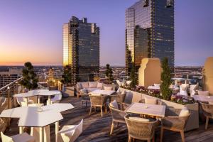 a restaurant with tables and chairs on the roof of a building at The Sinclair, Autograph Collection in Fort Worth