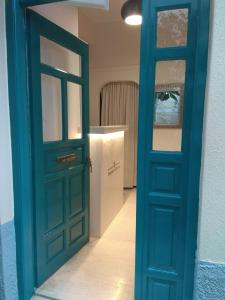 a blue door leading into a room with a counter at Filyra Pension in Nafplio