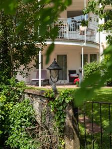 a lamp on a stone wall in front of a house at Hotel am Mühlbach in Forbach