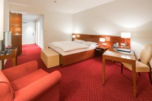 a hotel room with a bed and a desk and a couch at Hotel Rose in Bretzfeld +25 photos