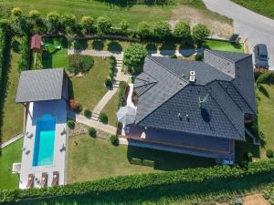 an aerial view of a house with a blue roof at Mala kuća Mia in Bosiljevo