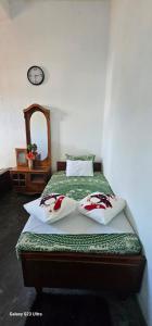 a bedroom with a bed with two pillows on it at Aloe Vera villa in Negombo