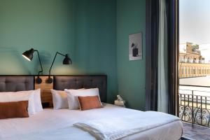 a bedroom with a large bed and a window at The Poet Hotel in La Spezia