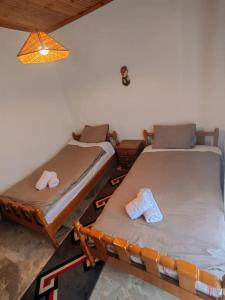 two beds are sitting in a room at Serenity Traditional House in Kalavrita