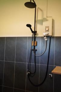 a shower in a bathroom with a shower head at House Bok Bowie in Koh Rong Sanloem