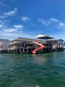 a resort with a slide in the water at Aloha Mabul Scuba Lodge in Pulau Mabul 