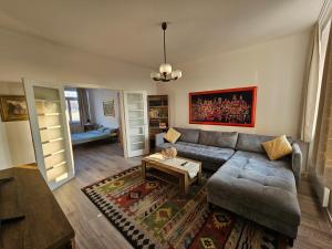 a living room with a couch and a table at Loga Apartment in Sarajevo