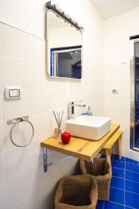 ein Bad mit einem Waschbecken und einem Spiegel in der Unterkunft Conte Bed & Breakfast Salerno Centro in Salerno