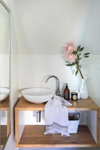 a bathroom with a sink and a vase with a flower at Broad Horizon in Scarborough