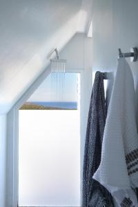 a bathroom with a window with a shower curtain at Broad Horizon in Scarborough