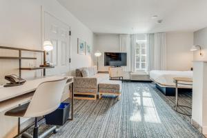 a hotel room with a bed and a couch at TownePlace Suites Dallas Arlington North in Arlington
