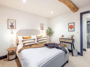 a bedroom with a large bed and a table at The Old Smithy in West Ashton