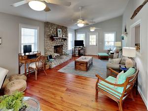 a living room with a couch and a fireplace at Nautical Watch in Tybee Island