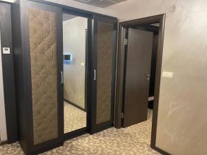 a row of glass doors in a hallway at Мия 2 Deluxe Royal Spa in Velingrad