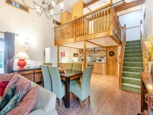 a dining room and kitchen with a wooden table and chairs at The Barn - Uk44514 in Tetney