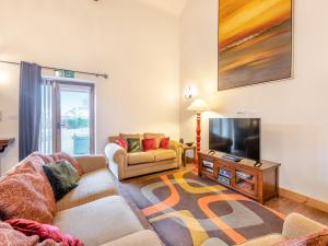 a living room with two couches and a flat screen tv at The Barn - Uk44514 in Tetney