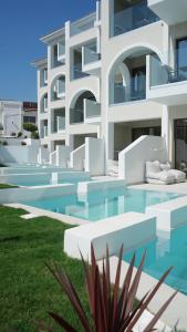 a large white building with a swimming pool at Diana Palace Hotel Zakynthos in Argassi