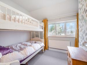a bedroom with a bunk bed and a window at Hide On The Hill in Theale