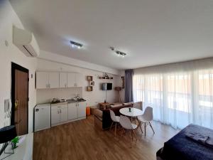 uma cozinha e uma sala de estar com mesa e cadeiras em Ohrid Sunlight em Ohrid