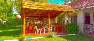 a gazebo with a table and chairs in a yard at Happy Morning Bliss. in Mirissa