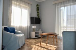 a living room with a couch and a table and a tv at Anastasia mare home #A# in Rethymno Town