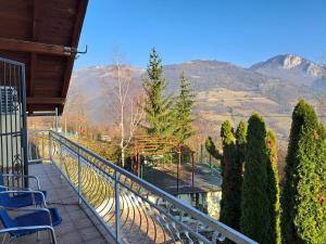 a balcony with chairs and a view of a mountain at VILLA ORYX free double garage parking in Sarajevo