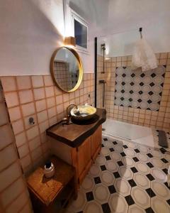 a bathroom with a sink and a tub with a mirror at Casa Malva - Traditional townhouse apartment in Monchique
