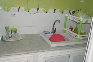 a kitchen counter with a sink with a faucet at Niveau de Villa entre Béjaïa et Jijel (Ziama) in Jijel