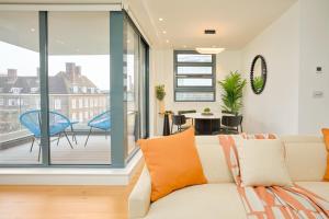 a living room with a couch and a balcony at Be London - Marylebone Apartments in London