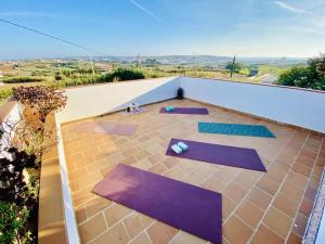 a group of purple yoga mats on a roof at Tiny House Eloá in Lourinhã