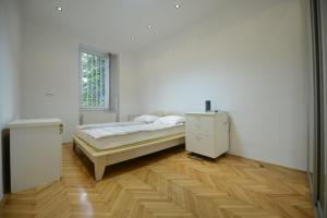 a white bedroom with a bed and a window at Park Lane Central Sarajevo in Sarajevo