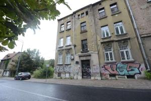 a building with graffiti on the side of it on a street at Park Lane Central Sarajevo in Sarajevo