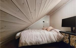 Bett in einem Zimmer mit Holzdecke in der Unterkunft Awesome Home In Urangsvg With Wifi in Ervik