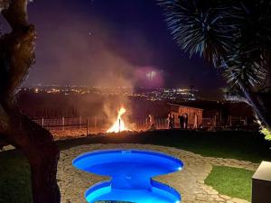 a fire in a field with a fire in the background at Da Silva Surfcamp, Tiny House Luna in Lourinhã