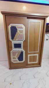 a wooden door with three windows in a room at One rela state in 6th Of October