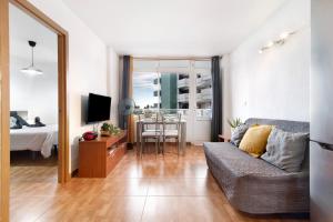 a living room with a couch and a table at Casa Lolina in Maspalomas