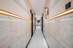 a hallway of a building with marble walls at FabHotel Royal Orbits in Surat