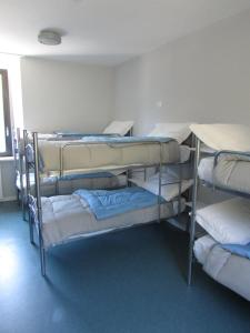 a group of bunk beds in a room at Ostello La Mine in Cogne