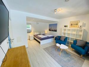 Habitación con cama, sofá y mesa. en Comfort-Appartment, en Überlingen