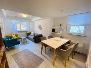 a living room with a table and a couch at Comfort-Appartment in Überlingen
