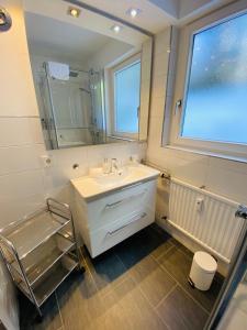 a bathroom with a sink and a mirror at Comfort-Appartment in Überlingen