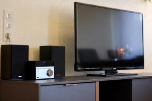 a flat screen tv sitting on a table with speakers at FeWo Louisa in Sipplingen
