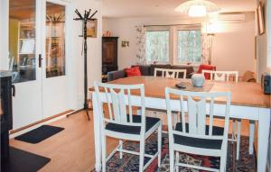 a kitchen and living room with a table and chairs at Awesome Home In Yngsj With House A Panoramic View in Yngsjö